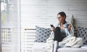 cozy woman looking at phone