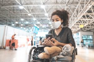 Latin american woman wearing protective mask in airport