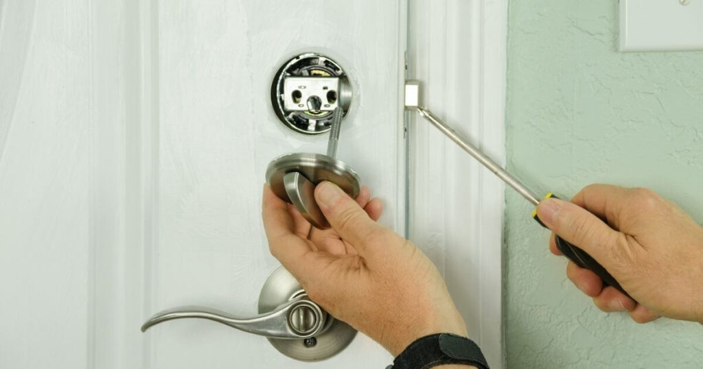 person installing a deadbolt lock