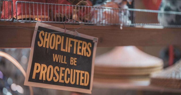 Shoplifters will be prosecuted sign stock photo
